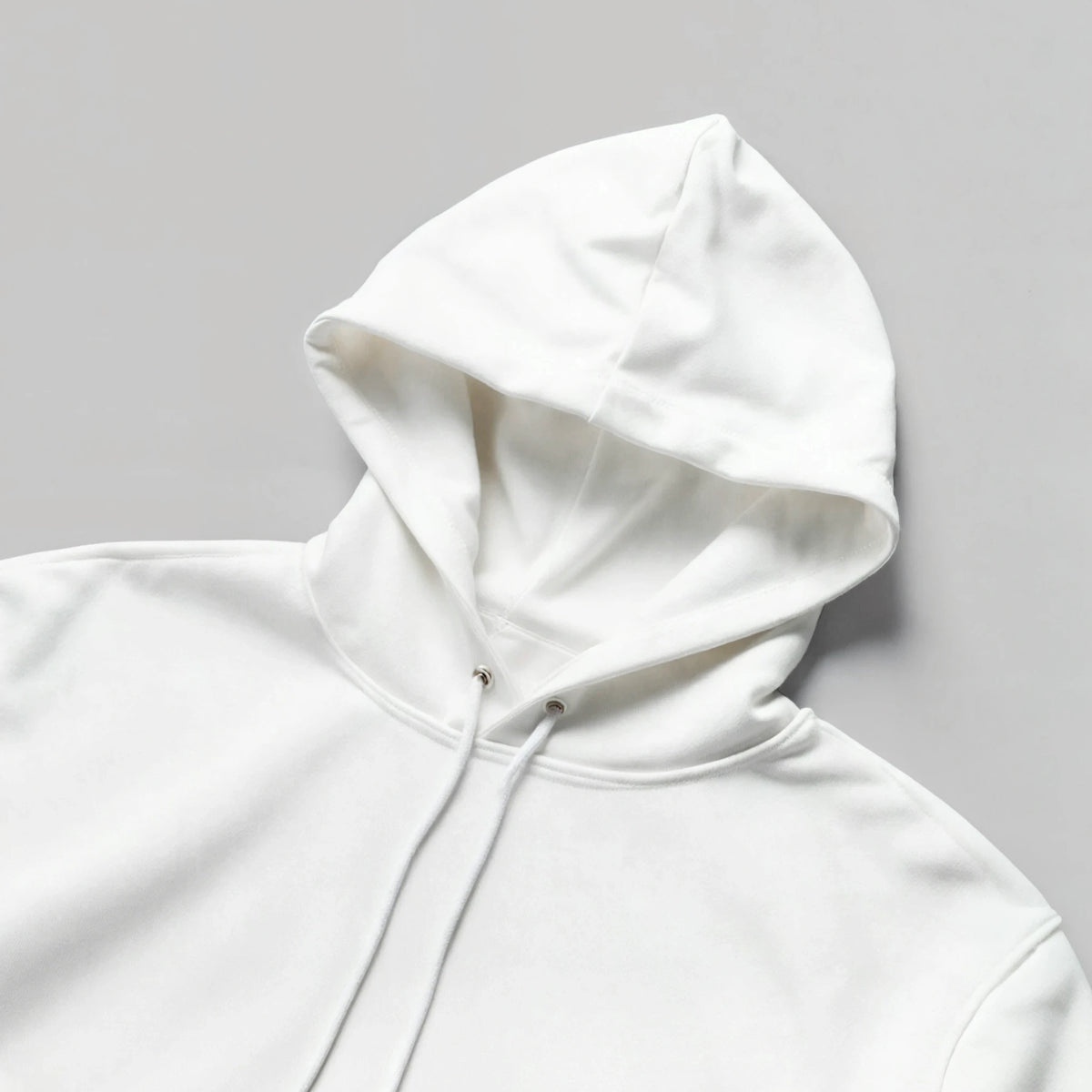 Front view of a white hoodie featuring the black “You Were Never Ordinary” statement design, shown as a clean product mockup with hood, drawstrings and front pocket visible.