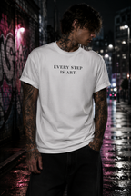 Tattooed men wearing a Personiq Kaleido T-Shirt with "Every step is art." front design and mininmalist streetwear style.