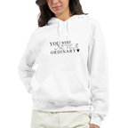 Close-up of a female model wearing a white hoodie with the black “You Were Never Ordinary” statement design on the front, shown from the chest up.