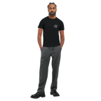 Black unisex statement T-shirt with a small white PK monogram on the chest, shown on a male model in a minimalist front view.
