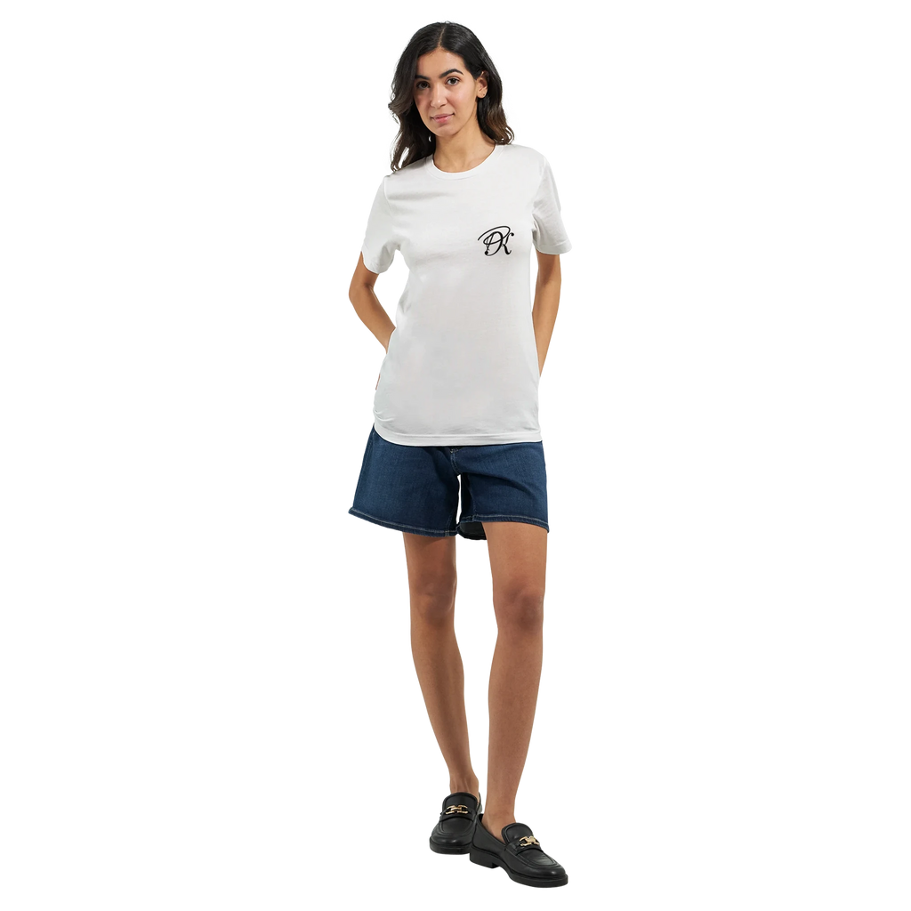 Female model wearing a white T-shirt with a small black PK logo on the chest, paired with denim shorts and black shoes, shown in a full-body front view for a clean, casual unisex streetwear look.