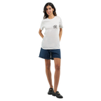 Female model wearing a white T-shirt with a small black PK logo on the chest, paired with denim shorts and black shoes, shown in a full-body front view for a clean, casual unisex streetwear look.