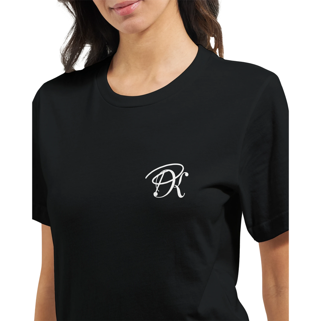 Close-up of a female model wearing a black “Color the Grey” unisex T-shirt, featuring a subtle white PK monogram on the front chest.