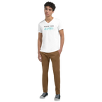 Full-body lifestyle mockup of a model wearing a white V-neck T-shirt featuring the motivational quote ‘MAKE TIME MATTER’ in black serif and turquoise handwritten typography, styled with casual pants and sneakers.