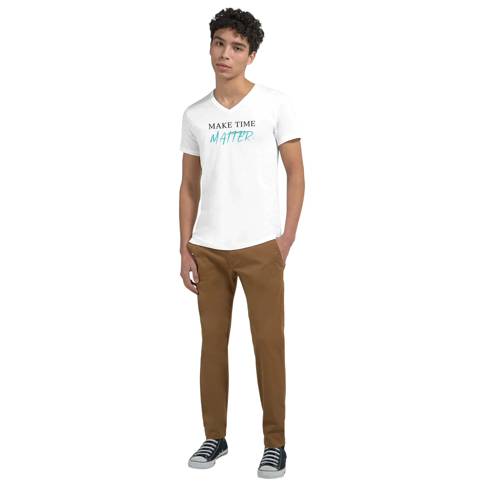 Full-body lifestyle mockup of a model wearing a white V-neck T-shirt featuring the motivational quote ‘MAKE TIME MATTER’ in black serif and turquoise handwritten typography, styled with casual pants and sneakers.
