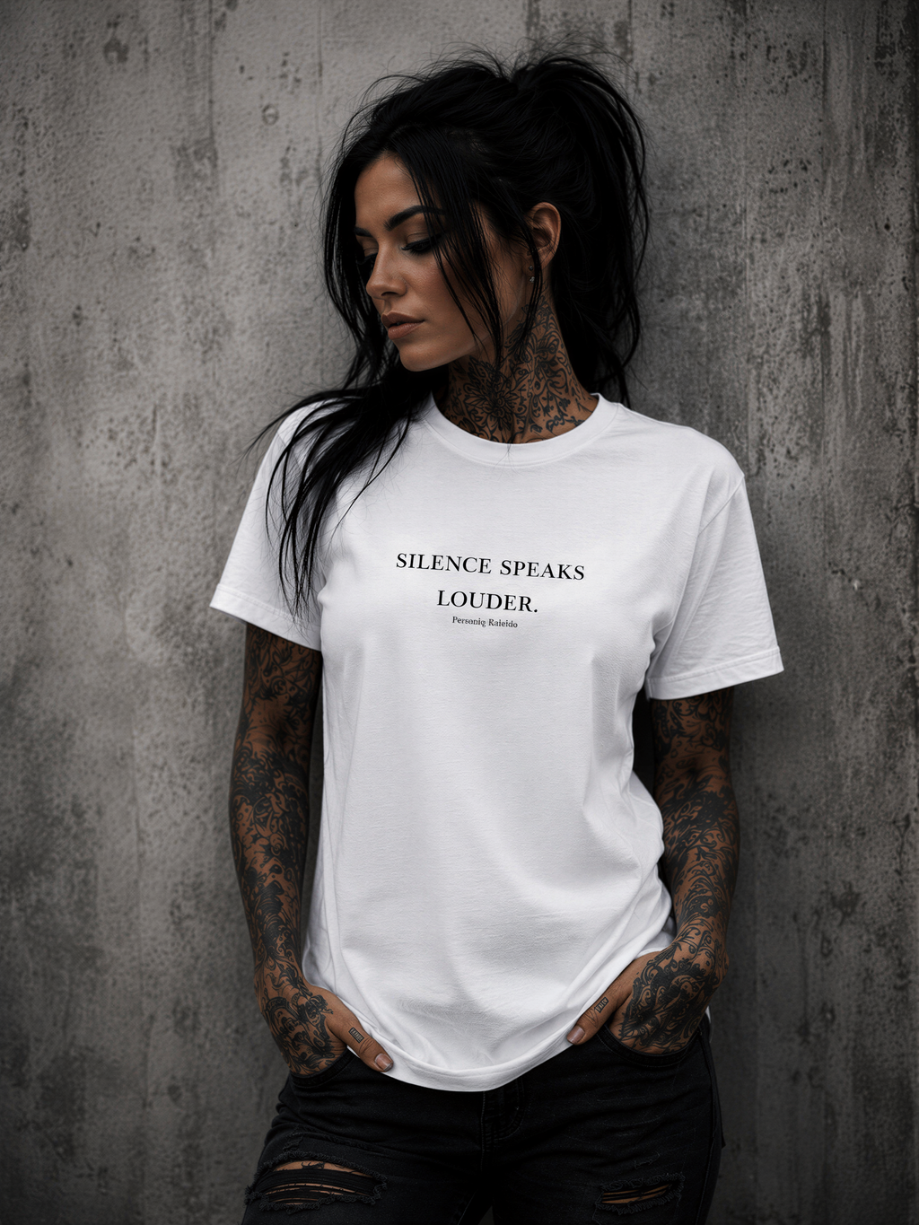Tattooed woman wearing a Personiq Kaleido T-Shirt with "Silence speaks louder." front design and mininmalist streetwear style.