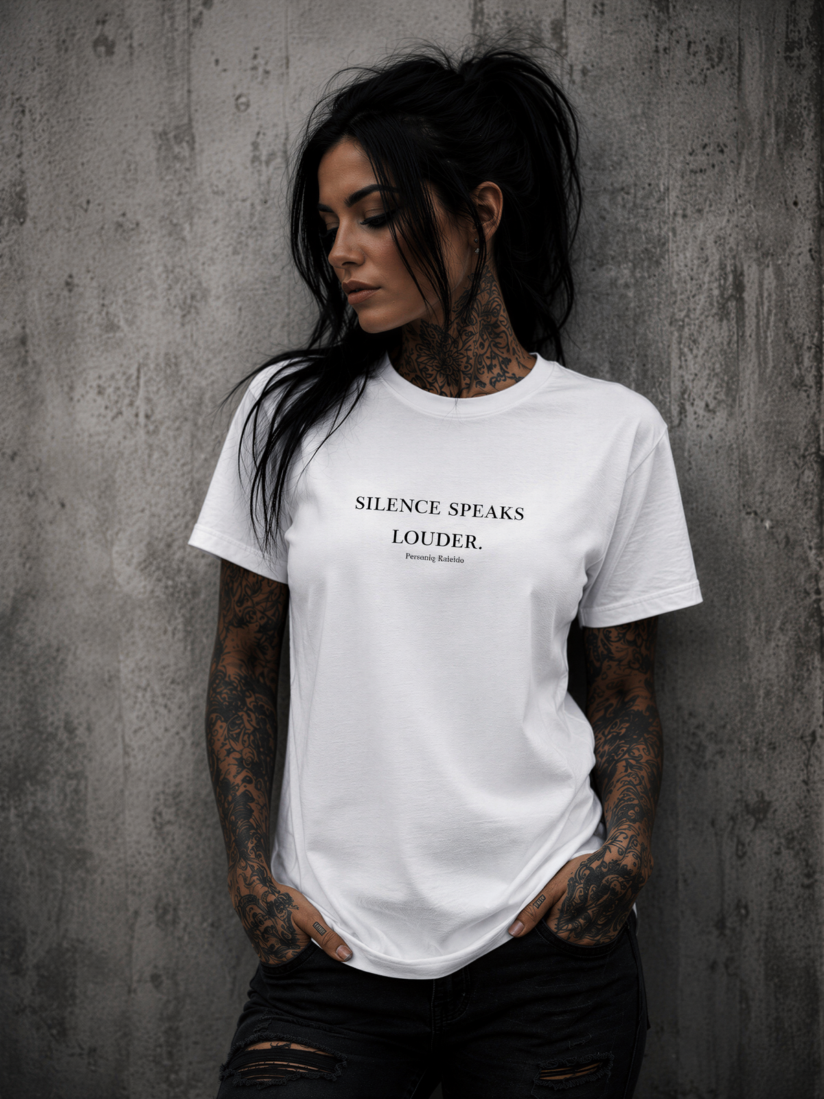 Tattooed woman wearing a Personiq Kaleido T-Shirt with "Silence speaks louder." front design and mininmalist streetwear style.