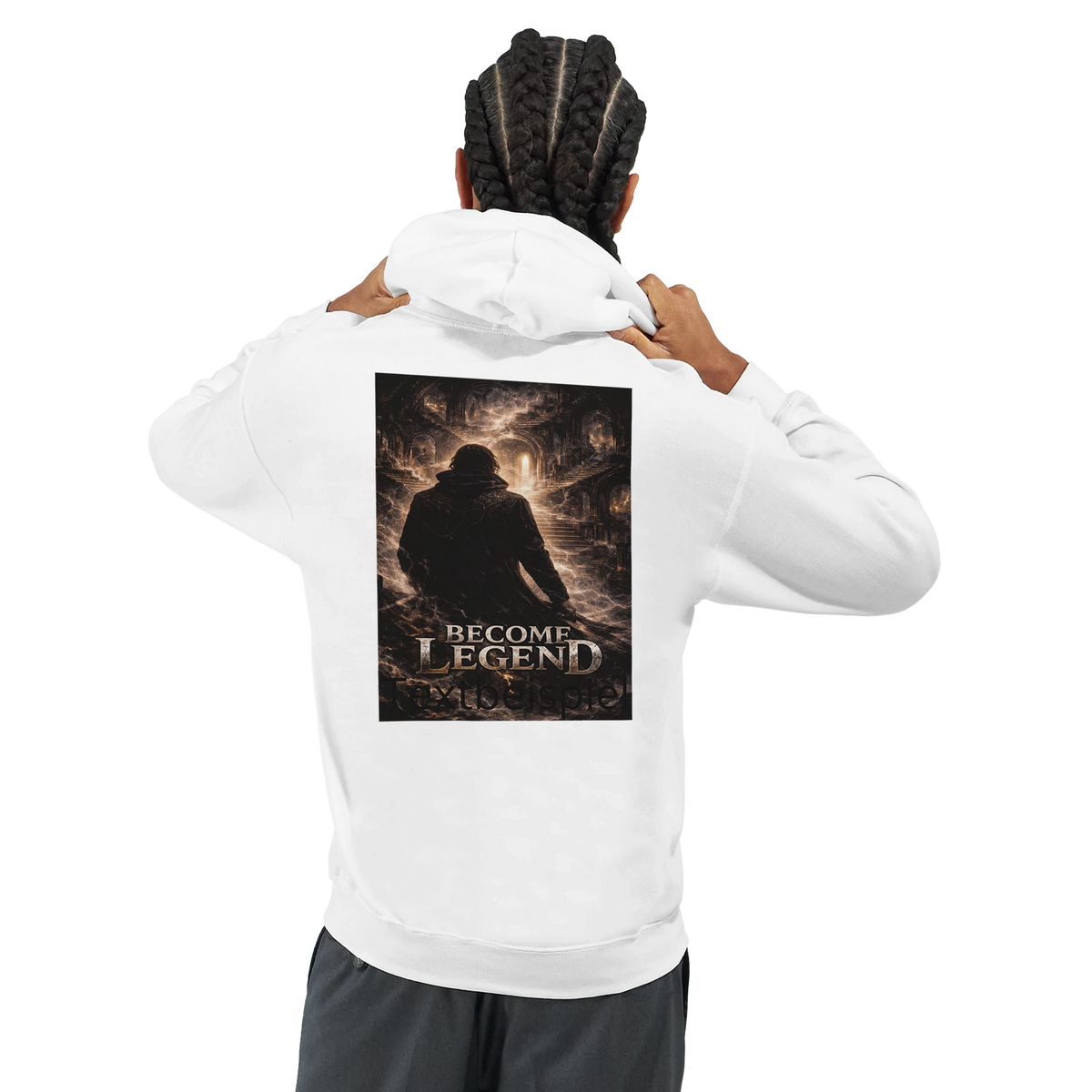 Back view of a male model wearing a white hoodie with a dark fantasy “Become Legend” graphic on the back, featuring a lone figure in a dramatic illuminated scene.