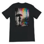 Back view of a black “Color the Grey” unisex T-shirt featuring a large monochrome umbrella silhouette and vibrant neon rainbow graffiti city artwork.