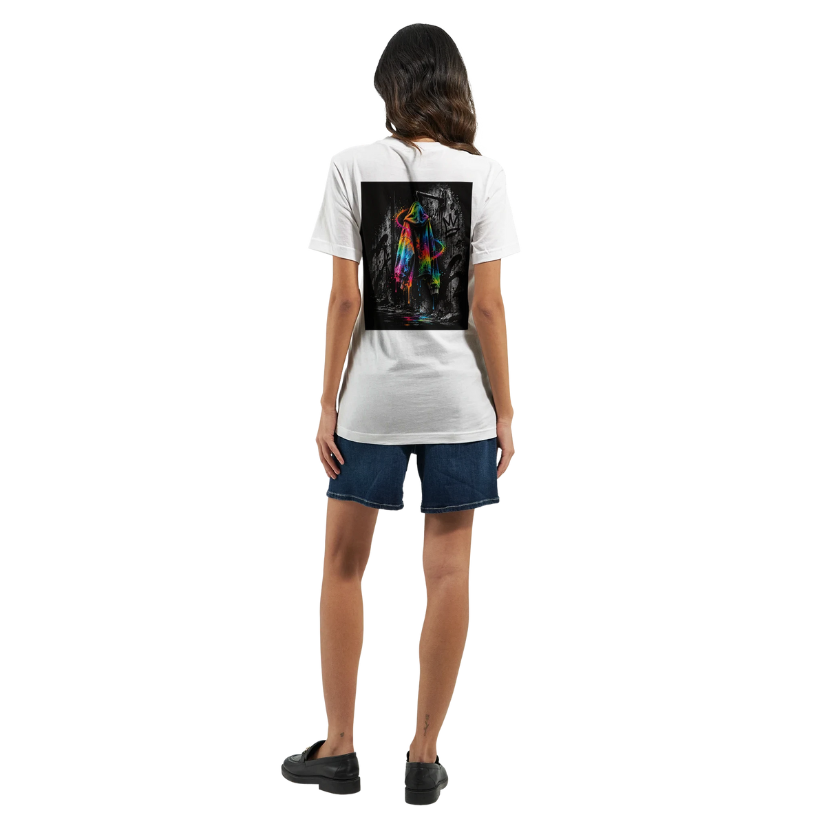 Female model shown from behind wearing a white T-shirt with a vivid neon rainbow hoodie back print against a black-and-white graffiti background, paired with a blue jeans rock for a modern urban streetwear look.