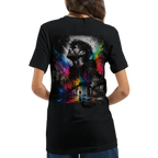 Female model shown from the back wearing a black unisex T-shirt with a large surreal urban artwork featuring a monochrome male portrait, city elements, and vivid rainbow neon color splashes.