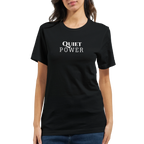 Female model wearing a black unisex T-shirt with a small white “QUIET POWER” chest print, shown from the front with blue jeans.