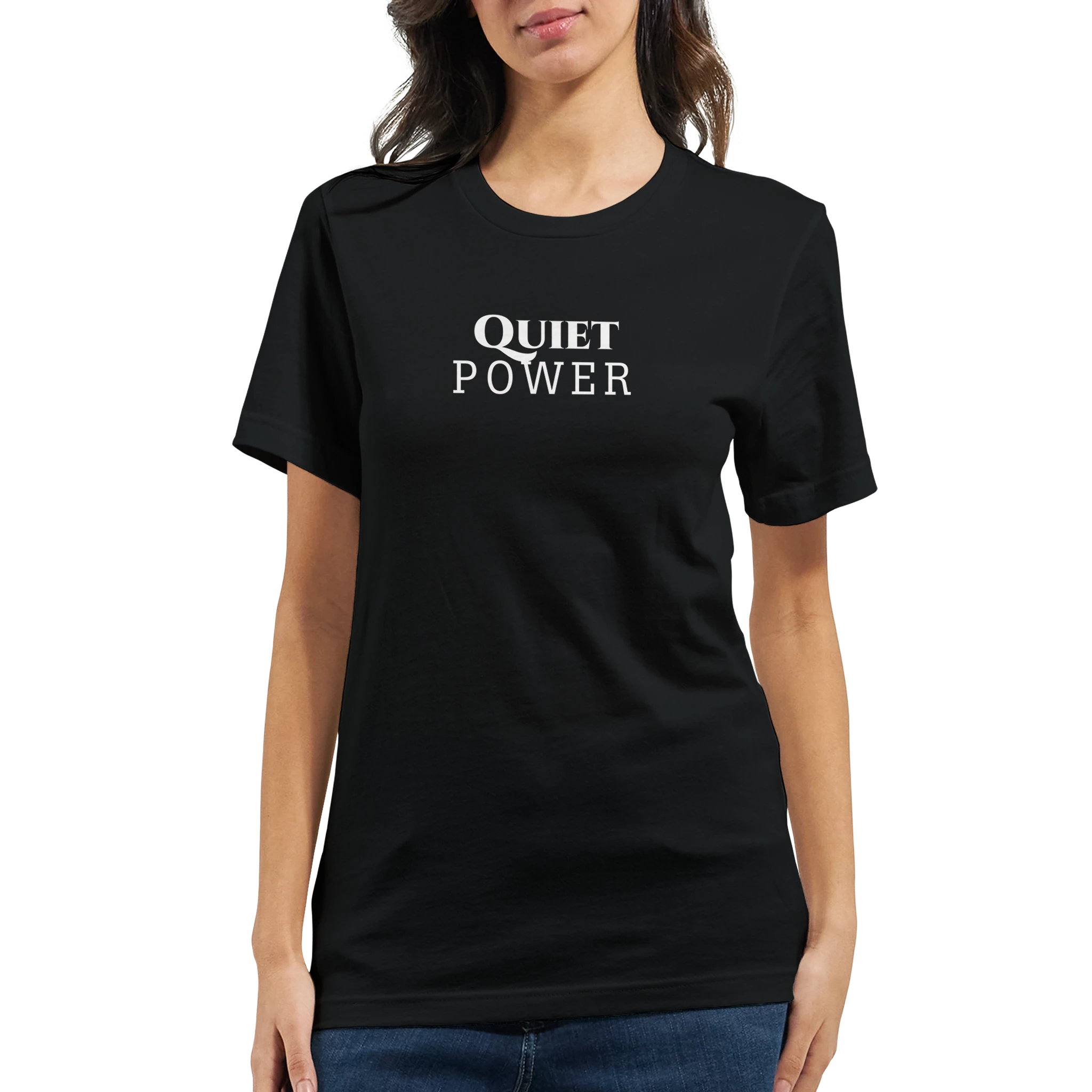 Female model wearing a black unisex T-shirt with a small white “QUIET POWER” chest print, shown from the front with blue jeans.