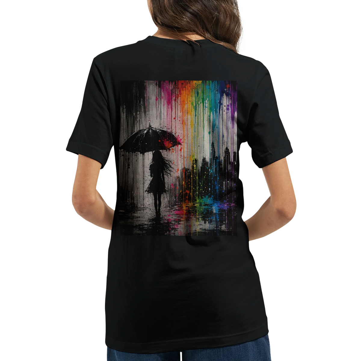 Black unisex T-shirt shown from the back featuring the “Color the Grey” design with a woman under an umbrella, a monochrome city skyline, and neon rainbow graffiti colors.