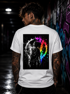 A person with tattoos on their back is wearing a white t-shirt with a graphic design featuring a black and white image of a person with a rainbow-colored design behind them.