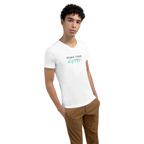 Young model wearing a white premium unisex V-neck T-shirt featuring the minimalist statement 'MAKE TIME MATTER.' on the front. The clean typography combines black serif lettering with a turquoise handwritten-style accent, creating a modern, motivational look focused on mindfulness, purpose, and intentional living.