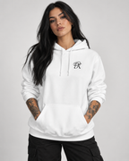 Tattooed female model wearing a white Personiq Kaleido hoodie with rolled-up sleeves, black chest monogram, kangaroo pocket and relaxed black cargo pants.