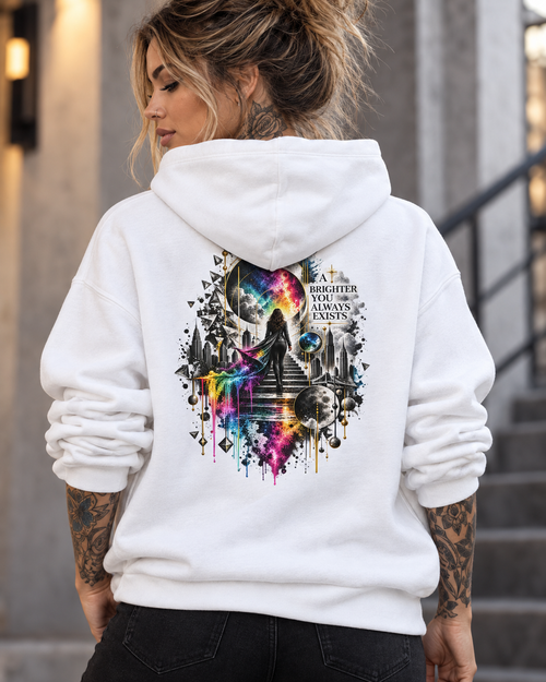 Female model wearing a white Personiq Kaleido hoodie with a surreal neon rainbow back print and “A Brighter You Always Exists” statement.